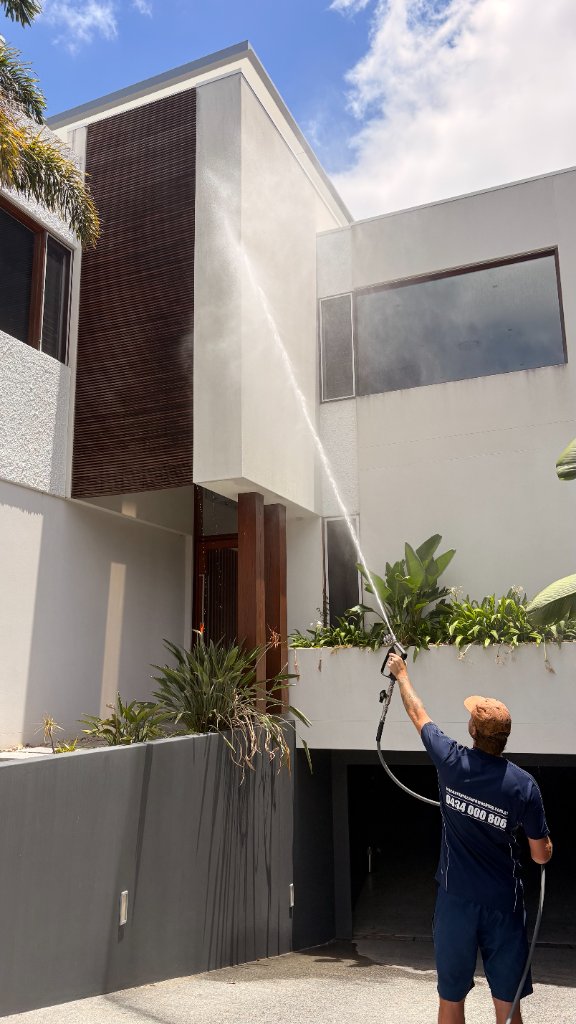 Professional pressure cleaning a modern Gold Coast home exterior